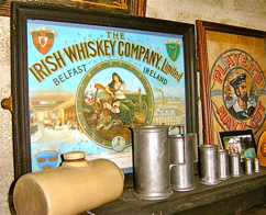 'The Irish Whiskey Company' and 'Player's Navy Cut' Signs, Pewter Jugs and Pottery Hot Water Bottle